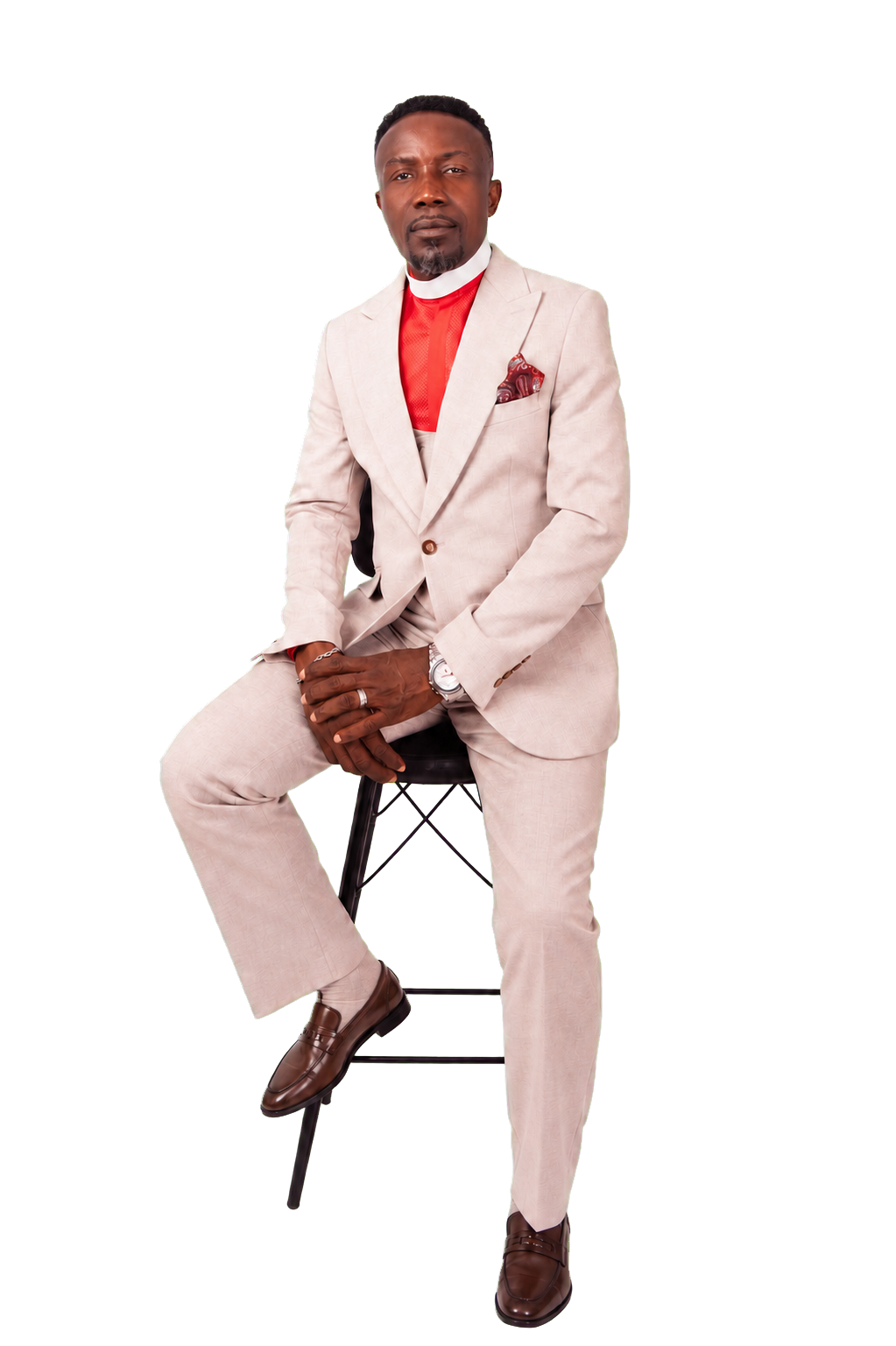 Apostle Isaac Kwabena Nana Adjei seated in a cream suit