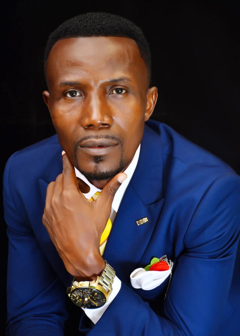 Close portrait of Apostle Isaac Adjei in a blue suit